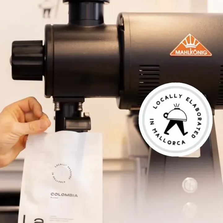 La Molienda coffee bag below the shop grinder.